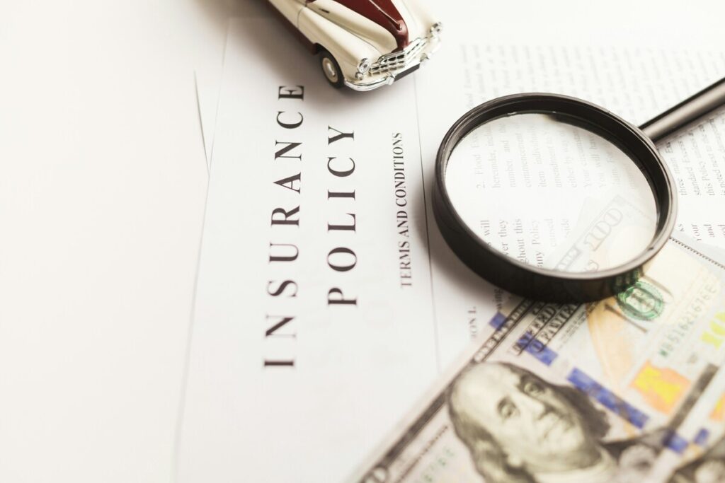 A magnifying glass placed above the insurance policy document
