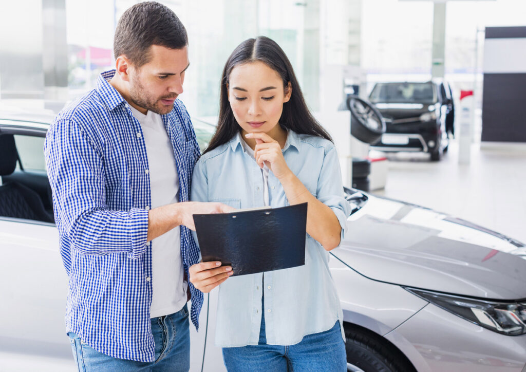 Man explaining car insurance to woman