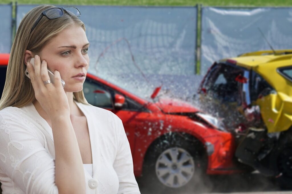 A woman is calling on the phone after a car crash