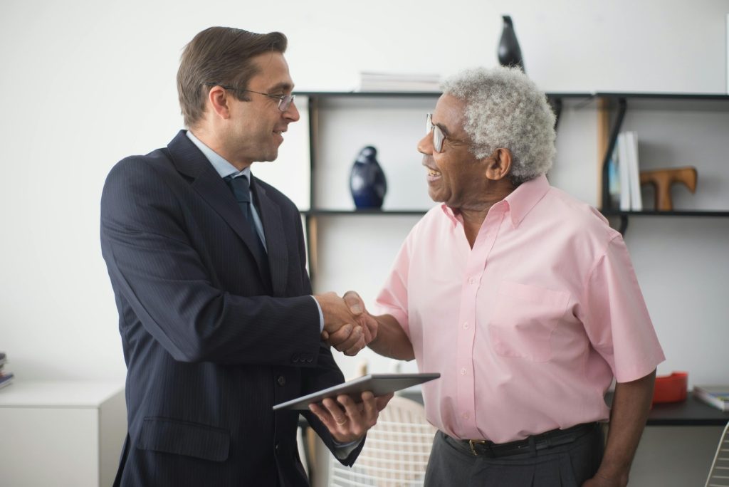 A person shaking hands with an insurance provider