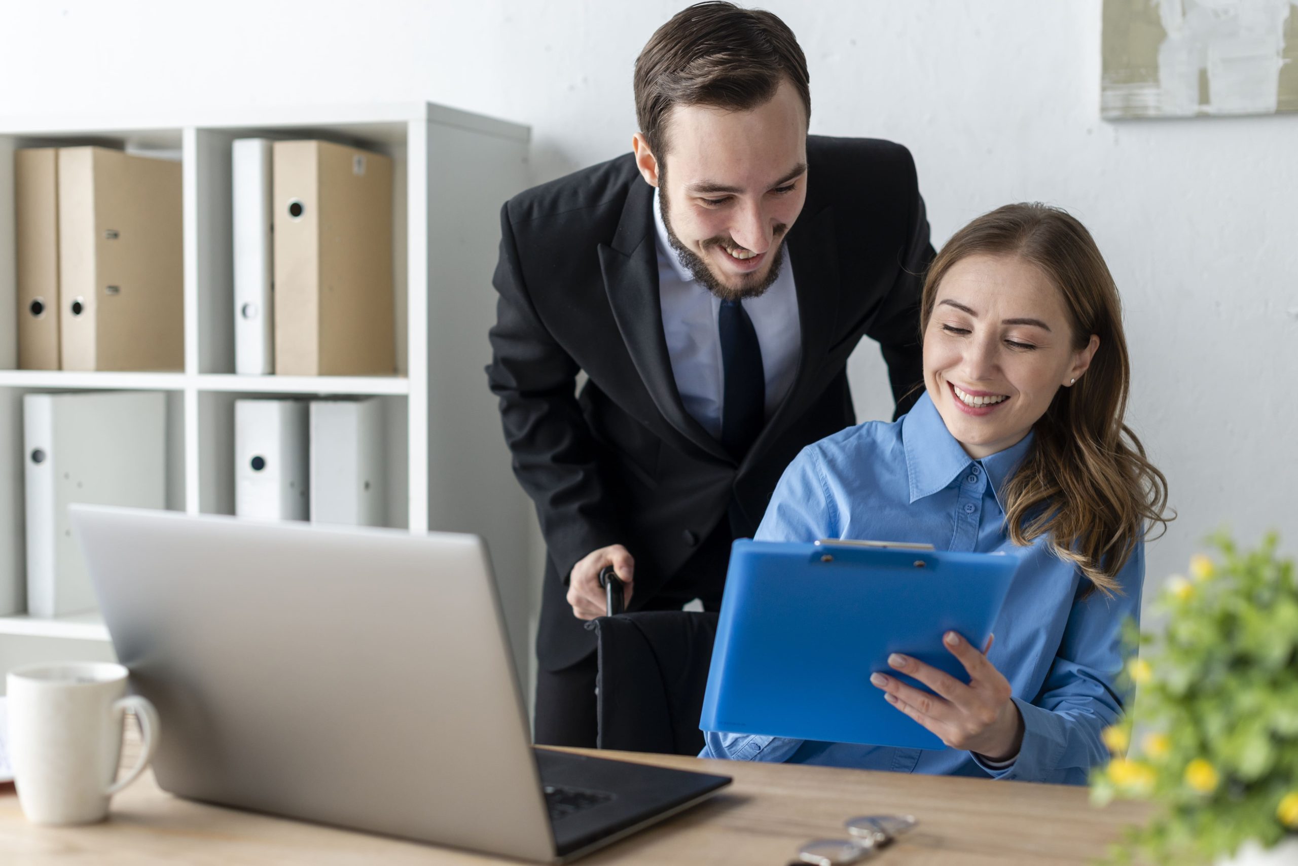 man and woman working together at the office