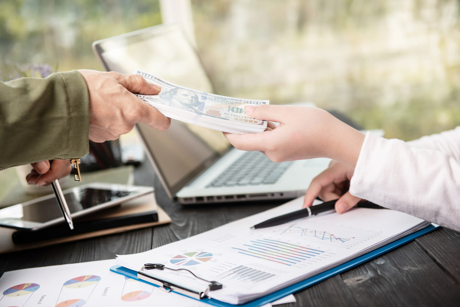 Businessman giving money to his worker