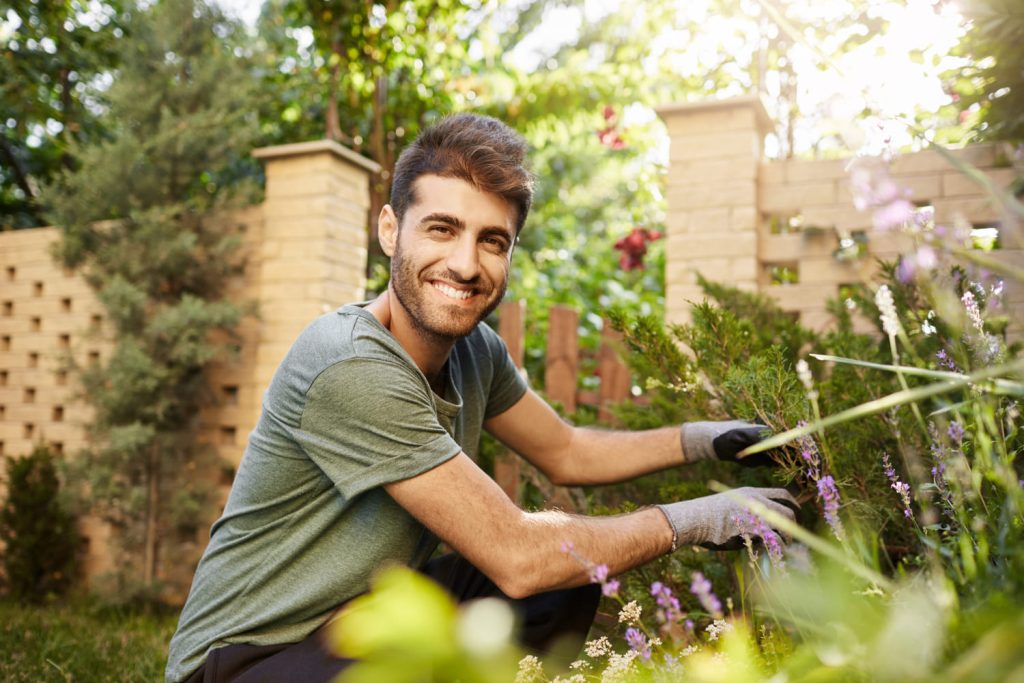 Cheerful man doing gardening