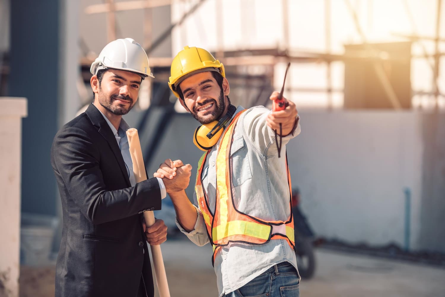Contractors handshaking at construction site