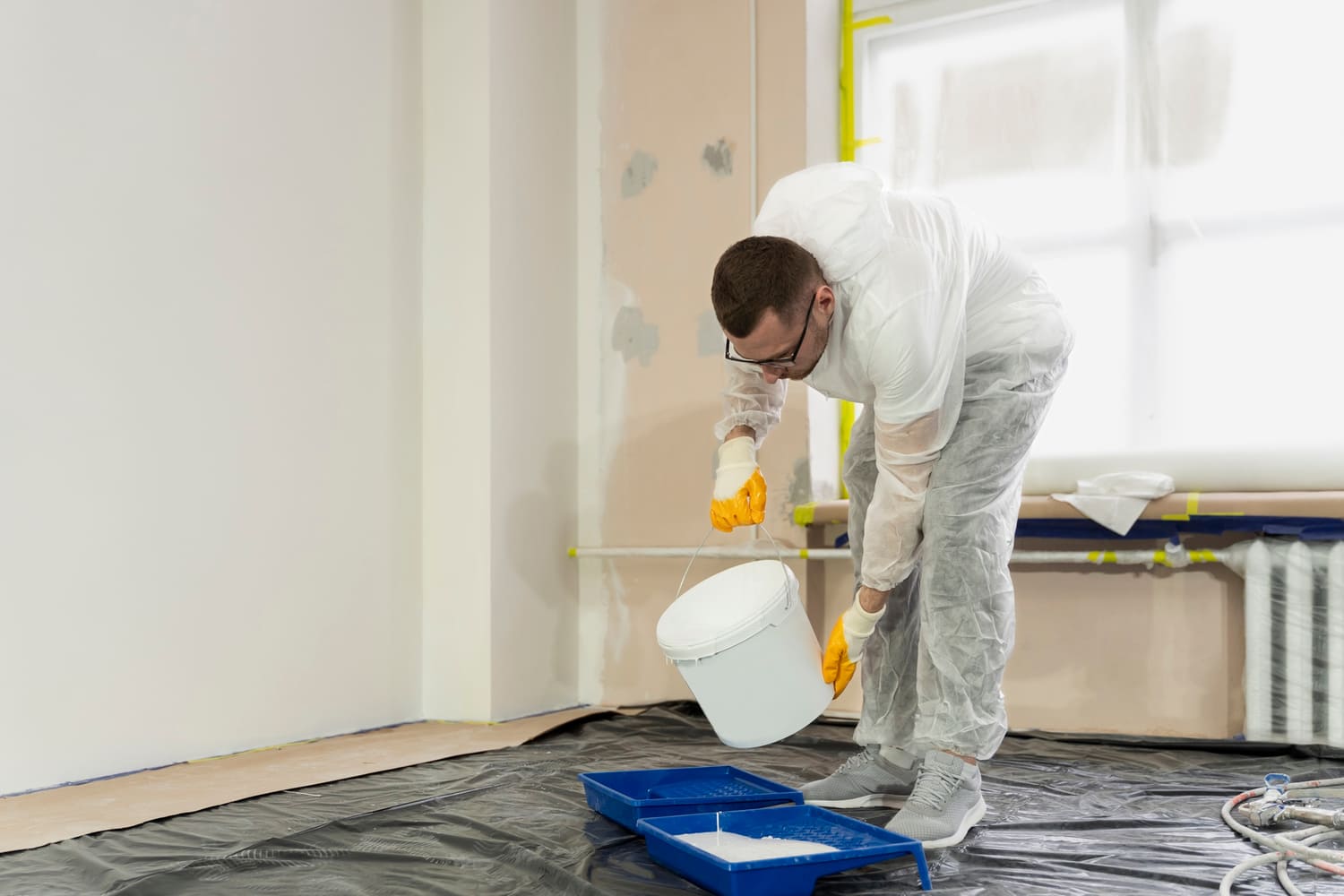 A man pouring paint