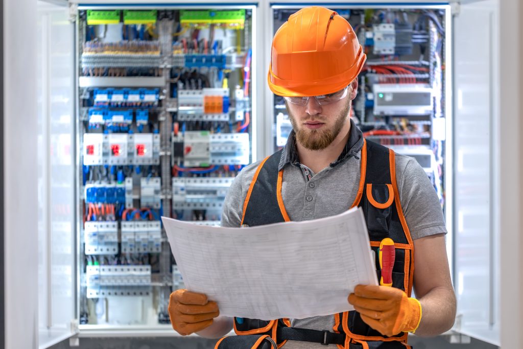 Male electrician reading the building map.